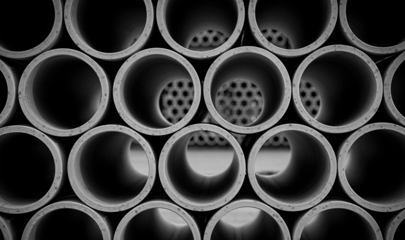 Stacked vitrified clay drainage pipes viewed end-on